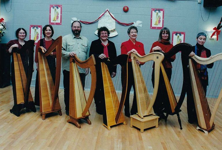 Seven members of the Ottawa Harp Choir posing with their harps.