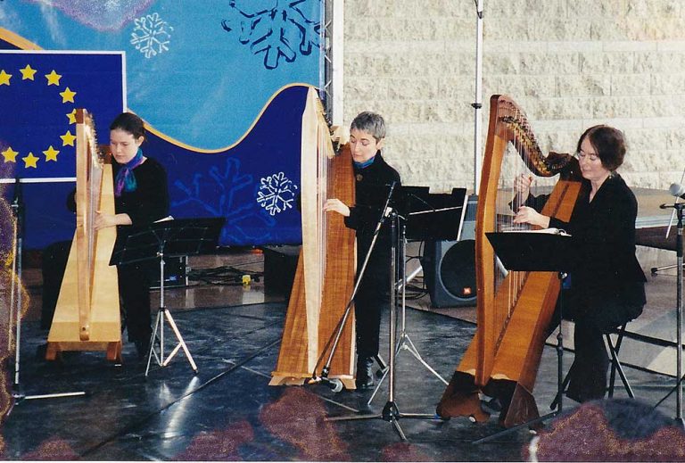 Three women (Mary Muckle on the right) playing harps at Ottawa city Hall