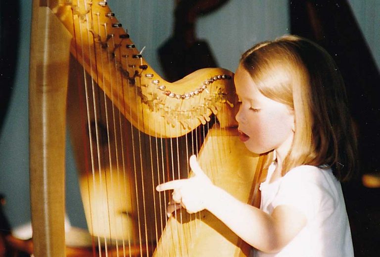 Young girl playing a harp